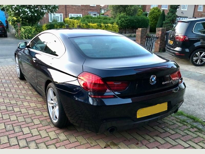A sleek silver BMW 6 Series parked, showcasing its elegant design.