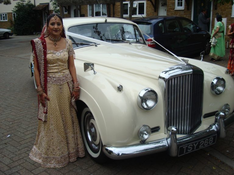 Interior view of the Bentley S1, showcasing the driver's seat for chauffeur hire.