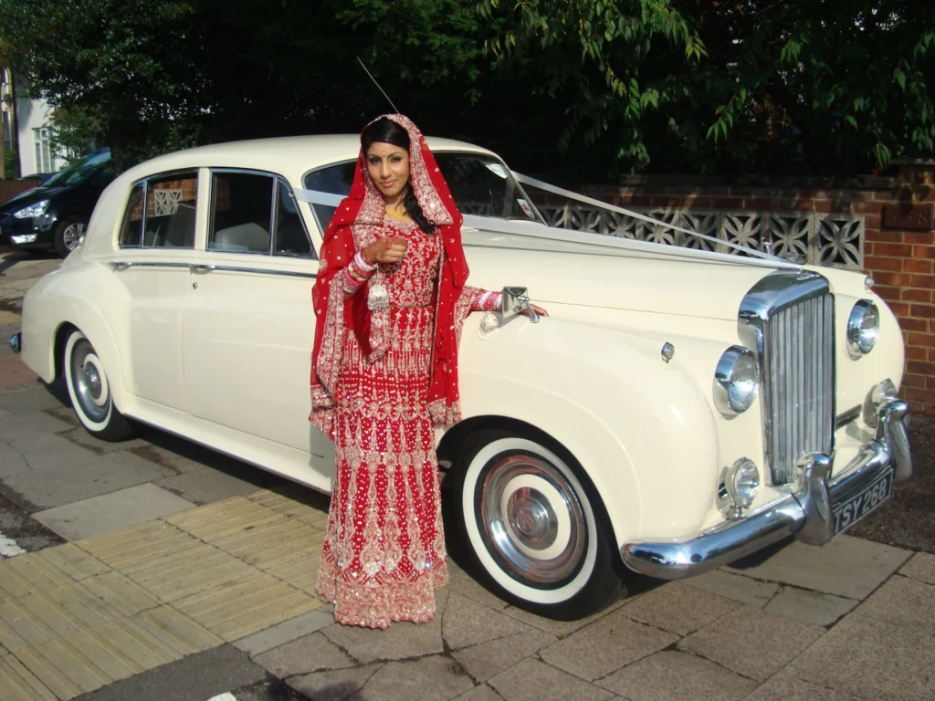 A chauffeur-driven Bentley S1 1956, viewed from the front, ready for hire.