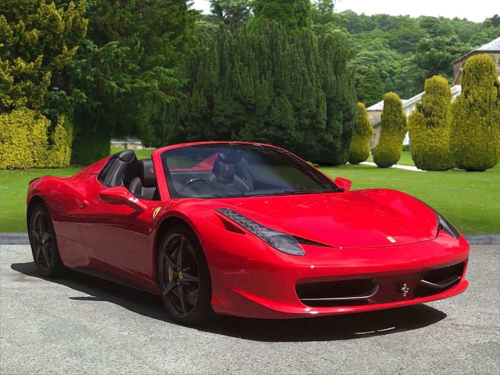 The sleek interior of a Ferrari 458 Italia Spyder, perfect for chauffeur hire.