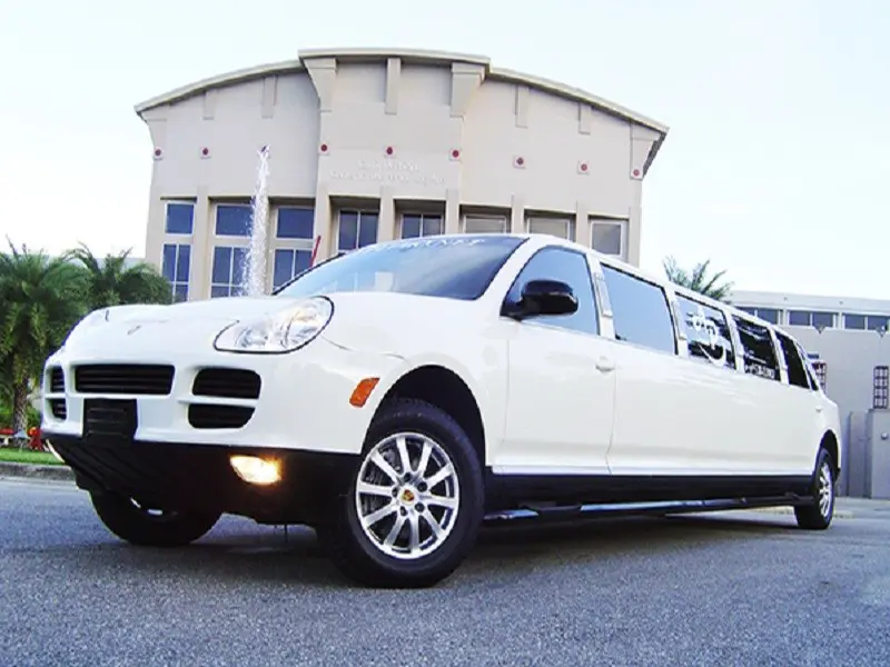 A white Porsche Cayenne Limousine ready for a special event.