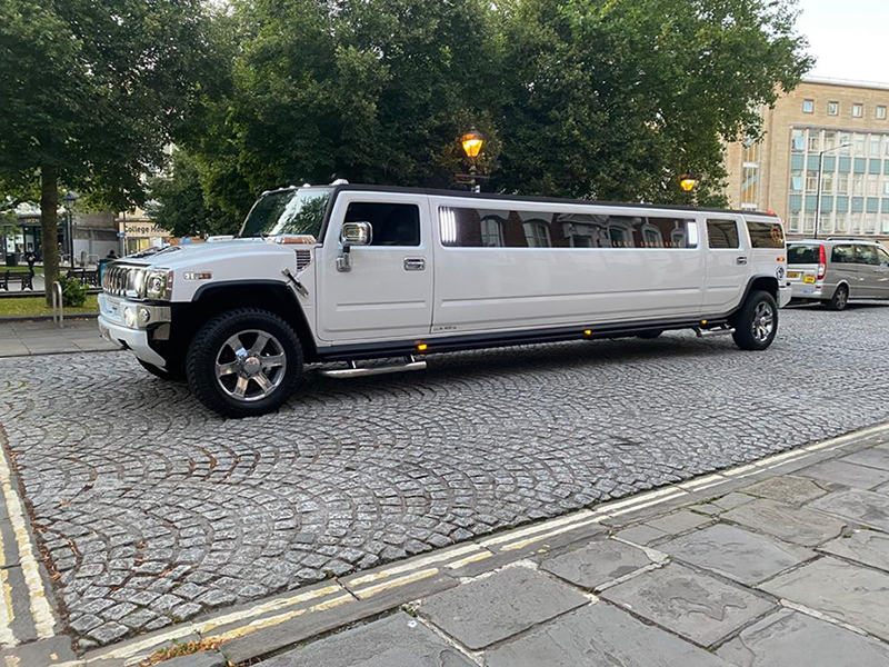 A classic white Hummer limousine, ideal for transporting the wedding party.